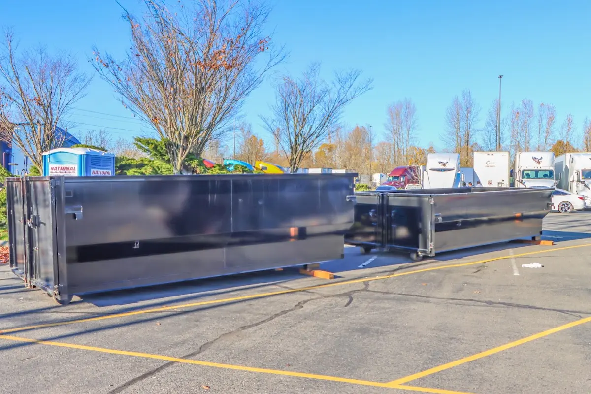 Professional dumpster rental service with roll-off container on residential driveway in White Rock